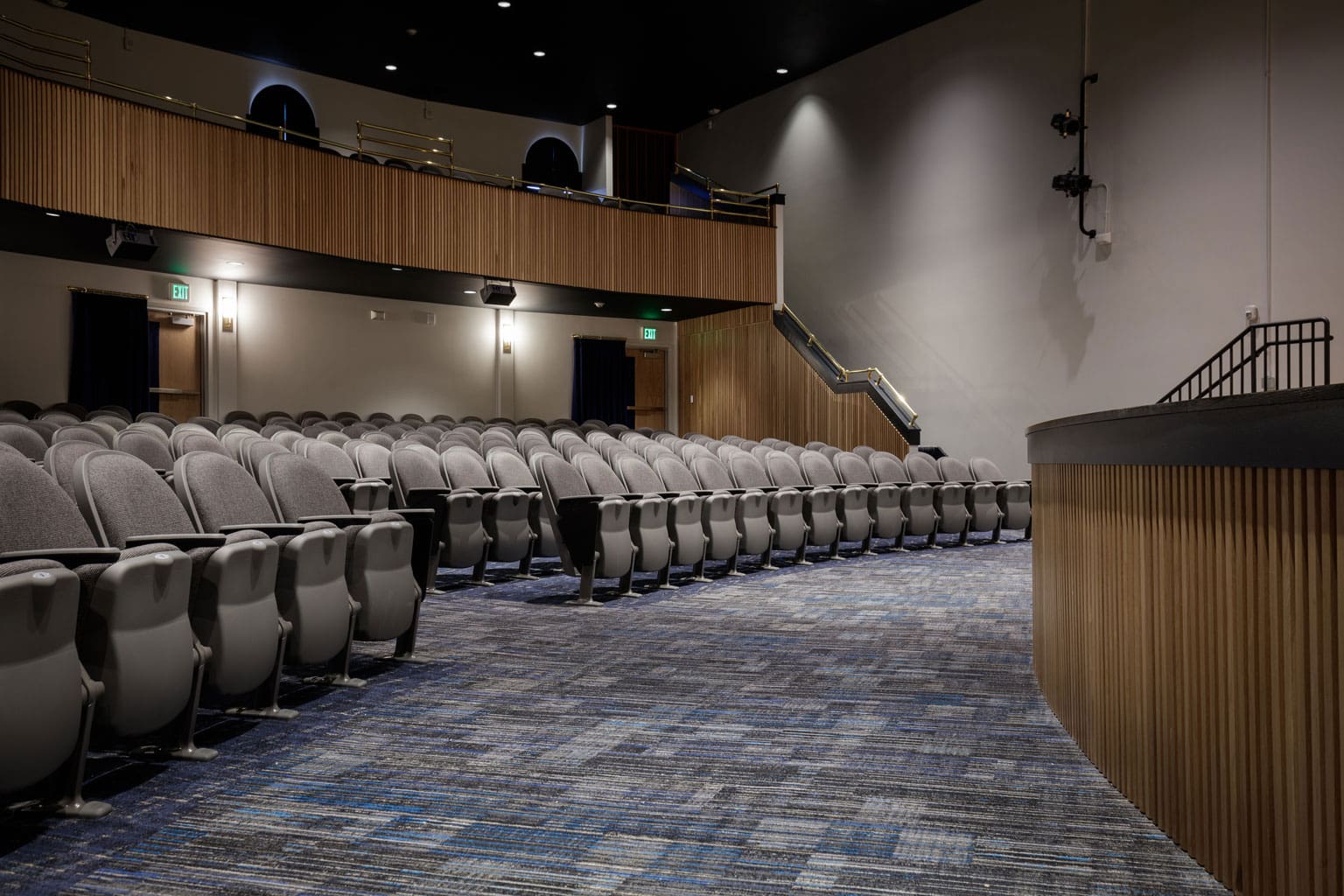 Curved Classic Slat Wood Wall Paneling in a school auditorium