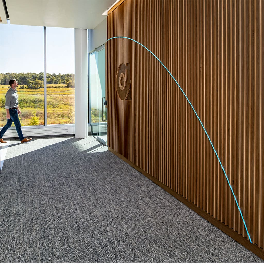 Fin Slat Wood Wall Paneling installed in a corporate lobby with logo