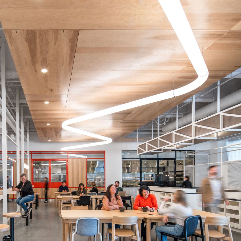Live Sawn Bright Ash Veneer Paneling installed as ceiling baffles in an open concept office space