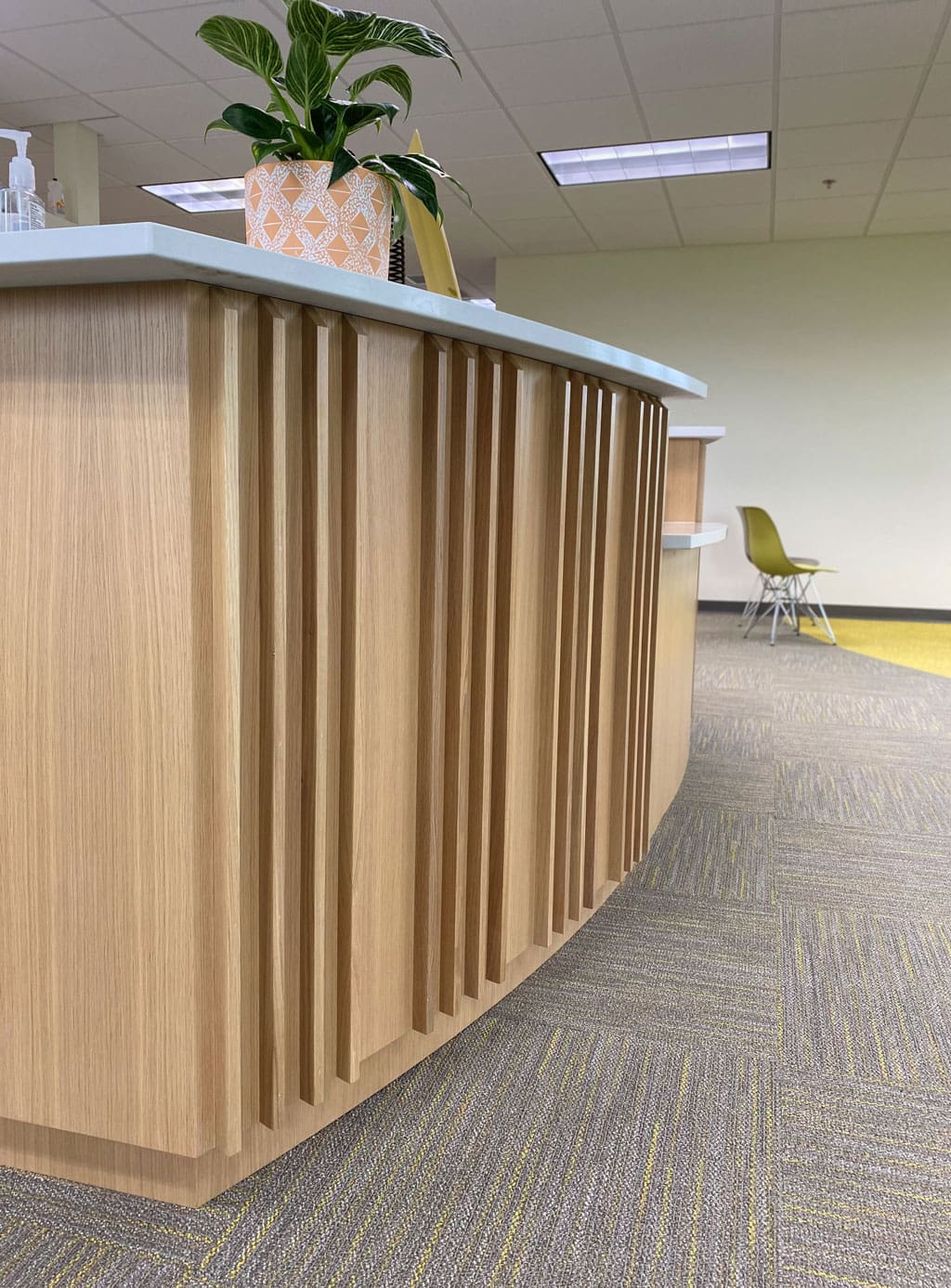 Reception Desk Featuring Custom Wood Wall Panels in Fin White Oak_Side View