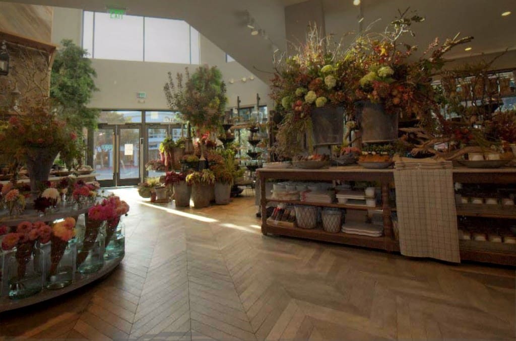 Reclaimed Skip-Planed Patina Pine Flooring in a retail floral shop with herringbone pattern