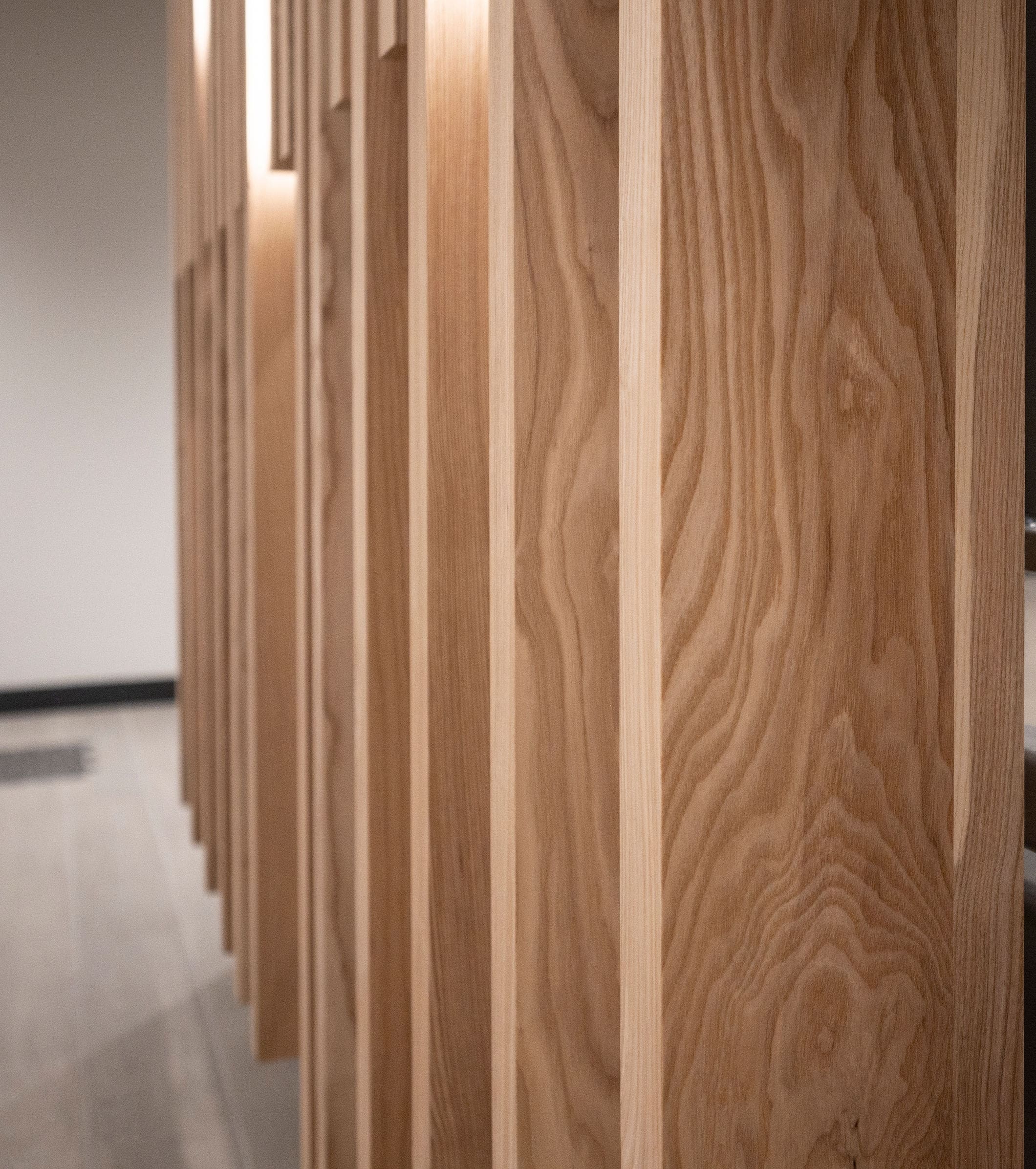 Close up of urban ash wood grain on Pass Through Slat Wood Walls