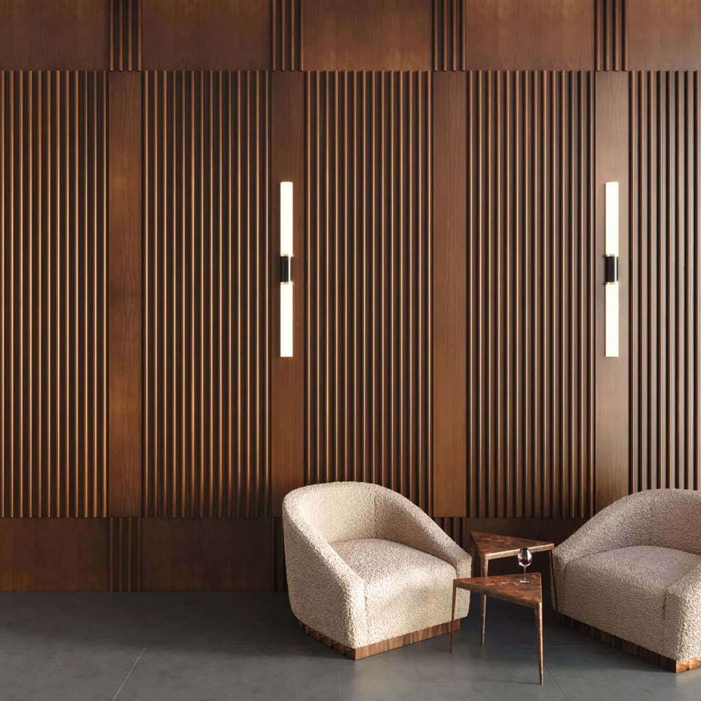 Two chairs in front of a custom feature wall with Torus Slat Wood Wall Panels and Companion Veneer Paneling in walnut with a premium oil finish