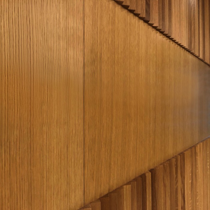 White Oak V-Rib Wall Panel in Premium Oil Finish Installed in Office Lobby